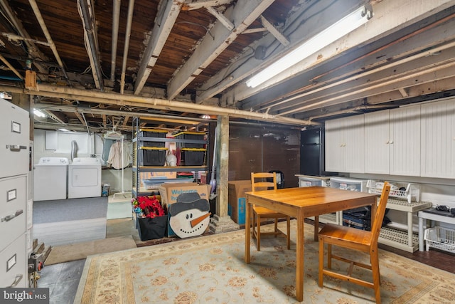 unfinished basement with washing machine and clothes dryer