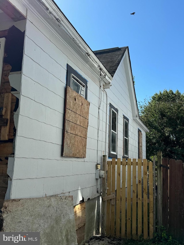 view of home's exterior with a gate