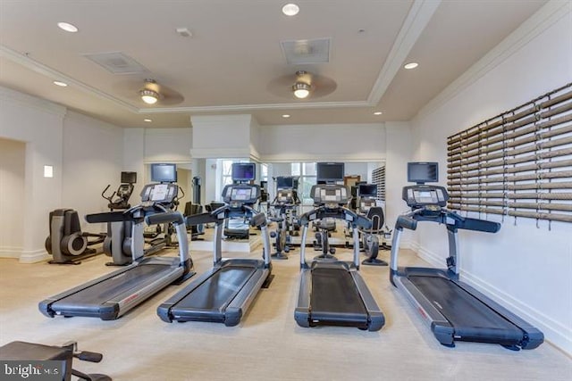 exercise room featuring a tray ceiling, crown molding, baseboards, and recessed lighting