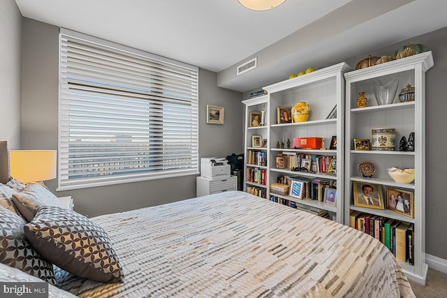 carpeted bedroom with visible vents and baseboards