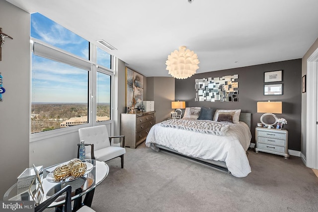 bedroom featuring baseboards, visible vents, and carpet flooring