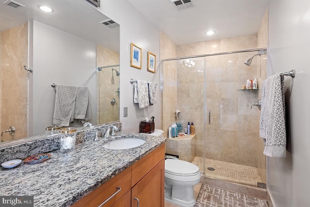 full bath with toilet, vanity, and visible vents