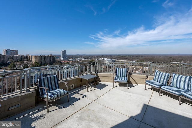 view of patio / terrace featuring a view of city, outdoor lounge area, and a balcony