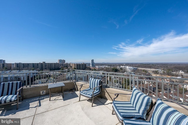 view of patio featuring a balcony and a city view