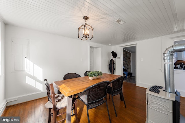 dining space with a notable chandelier, dark wood-style flooring, visible vents, and baseboards