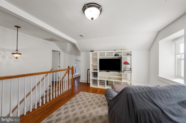 bedroom featuring visible vents, vaulted ceiling, and wood finished floors