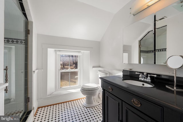 full bathroom with visible vents, toilet, vaulted ceiling, a shower stall, and vanity