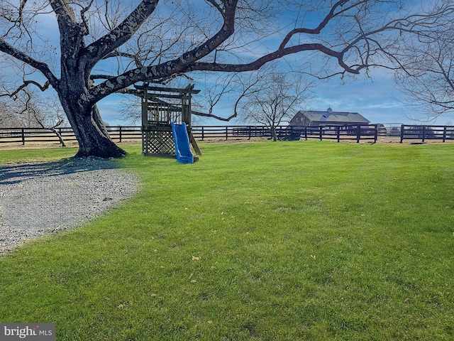 view of yard with a rural view and fence