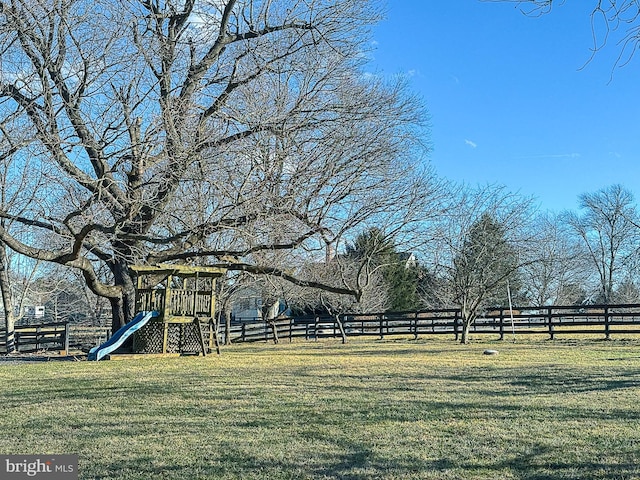 view of yard with playground community and fence