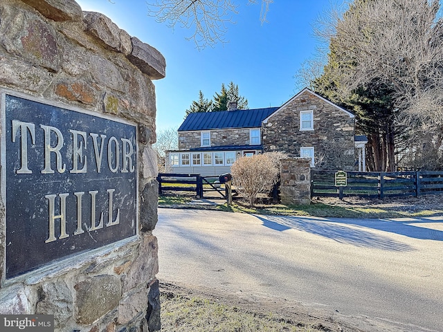 community / neighborhood sign featuring fence