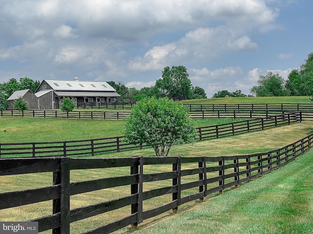 view of yard with a rural view and fence