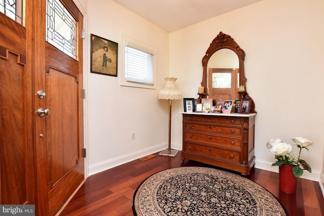 entrance foyer featuring dark wood-style flooring and baseboards