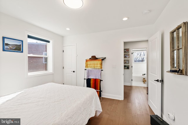 bedroom with recessed lighting, wood-type flooring, and baseboards