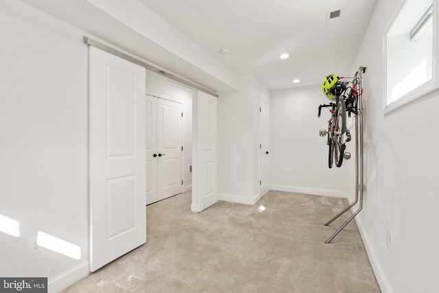 interior space with baseboards, recessed lighting, visible vents, and light colored carpet