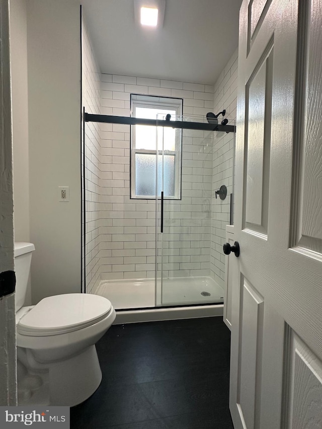 full bathroom with toilet and a shower stall