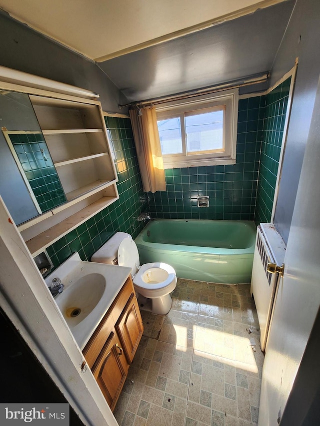 bathroom with tasteful backsplash, toilet, radiator heating unit, vanity, and tile walls