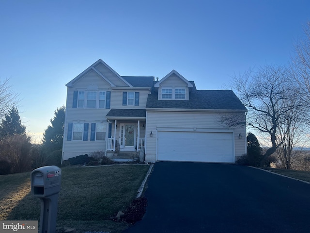 traditional home with driveway, a shingled roof, and an attached garage