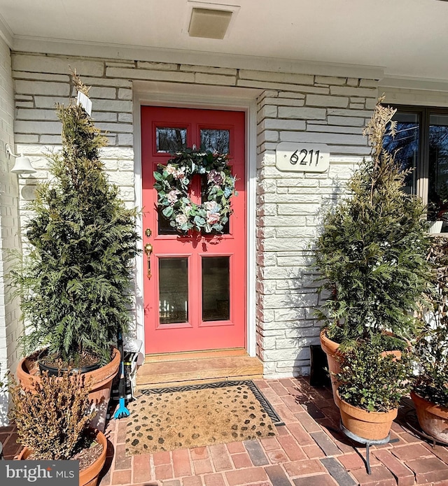 property entrance with brick siding