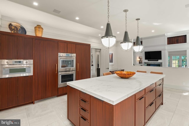 kitchen featuring recessed lighting, a kitchen island, double oven, and open floor plan