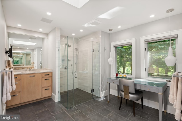 full bath with a shower stall, recessed lighting, a skylight, tile patterned floors, and vanity