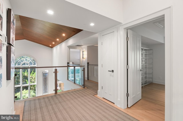 hall with visible vents, recessed lighting, vaulted ceiling, wood ceiling, and an upstairs landing