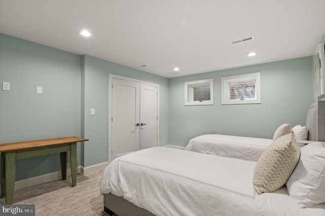 carpeted bedroom with a closet, visible vents, recessed lighting, and baseboards