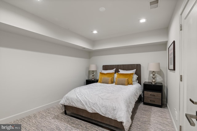 carpeted bedroom with visible vents and baseboards