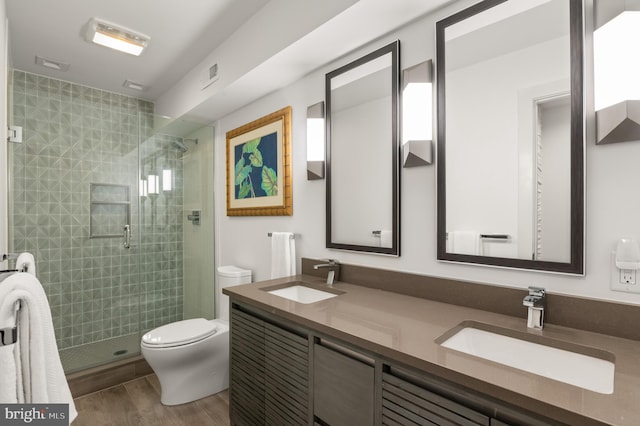 full bath featuring a sink, toilet, and a shower stall