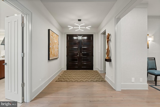 entrance foyer featuring light wood-style flooring and baseboards