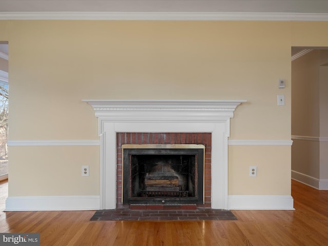 details with baseboards, a fireplace, wood finished floors, and crown molding