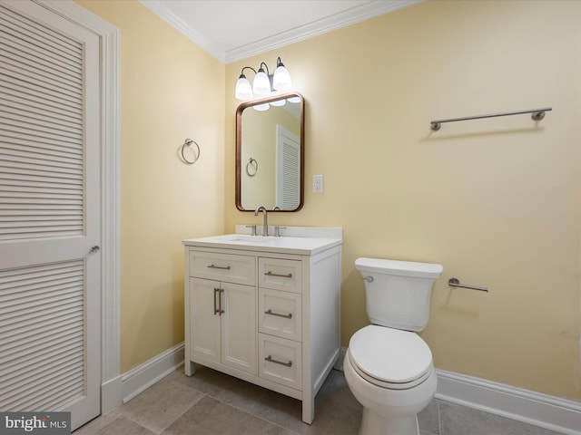 bathroom featuring baseboards, toilet, ornamental molding, vanity, and a closet