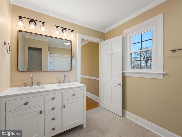 bathroom with ornamental molding, a sink, baseboards, and double vanity