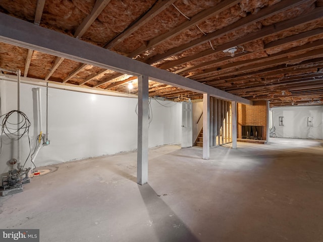 unfinished basement featuring stairs