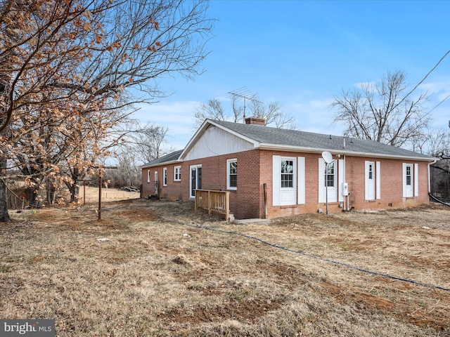 view of front of house featuring brick siding, a chimney, and roof with shingles