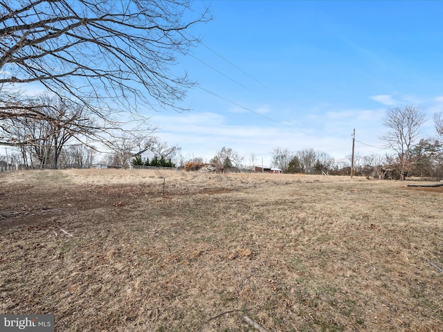 view of yard with a rural view