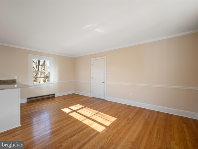 unfurnished room with ornamental molding, light wood-type flooring, baseboards, and baseboard heating