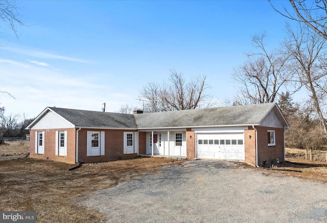 single story home featuring brick siding, driveway, an attached garage, and roof with shingles