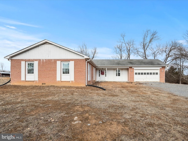 view of front of home featuring a garage, driveway, and brick siding