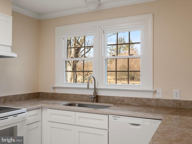 kitchen featuring white appliances, a sink, white cabinets, light countertops, and crown molding