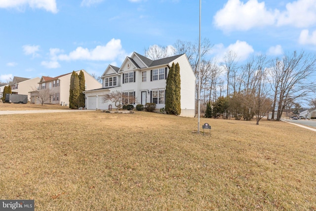 view of front facade featuring a front yard and an attached garage