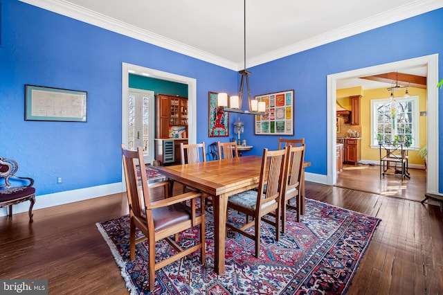 dining room featuring ornamental molding, beverage cooler, hardwood / wood-style floors, and baseboards