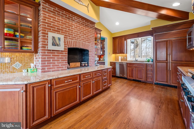 kitchen with tasteful backsplash, light wood-style flooring, lofted ceiling with beams, stainless steel dishwasher, and glass insert cabinets