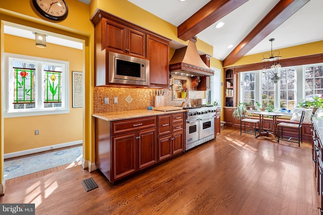 kitchen with stainless steel appliances, dark wood-style flooring, visible vents, backsplash, and custom exhaust hood