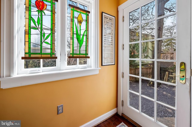 doorway to outside featuring baseboards