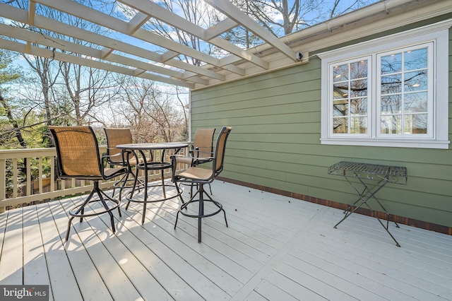 deck with outdoor dining area and a pergola