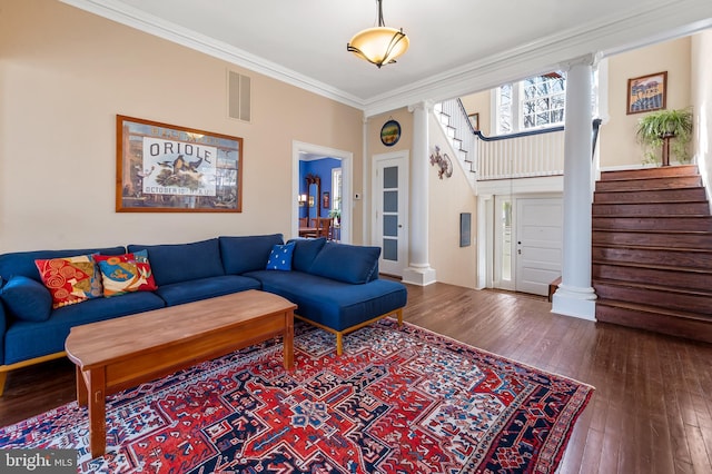 living room featuring visible vents, stairs, ornamental molding, hardwood / wood-style floors, and decorative columns