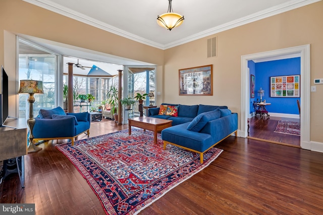 living area with baseboards, visible vents, ornamental molding, and hardwood / wood-style floors