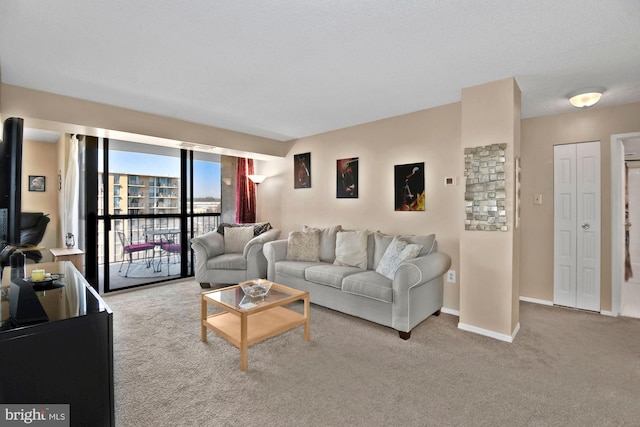 living area featuring light carpet and baseboards