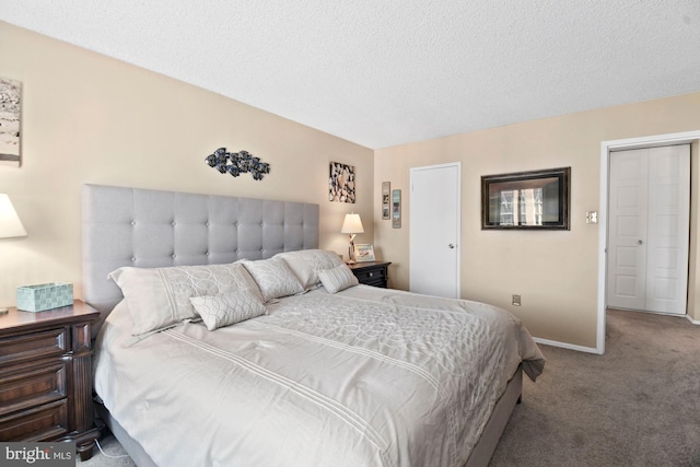 bedroom with carpet floors, baseboards, and a textured ceiling