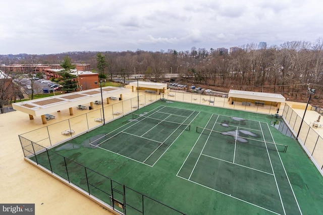 view of sport court featuring fence